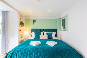 布莱顿霍夫Luxury at The Brunswick - Free Parking-4 bedrooms的一间卧室配有蓝色的床和两个枕头