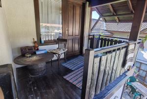 斯莫梁Guest house Smolyan的阳台配有木桌和木栏杆。