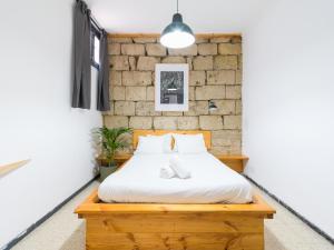 大加那利岛拉斯帕尔马斯Cathedral Apartment的一间卧室设有一张床和砖墙