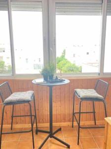 雷塔马尔Ático Parque Natural Cabo de Gata的一张桌子,两把椅子,一张桌子,上面有植物
