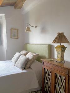OrfesBartró de Orfans的一间卧室配有一张床和木桌上的灯