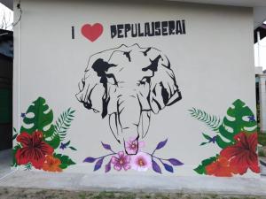 北根Depulauserai Budget Home No AirCond的建筑一侧的大象壁画