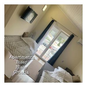 布拉采Apartments BISER的一间卧室设有一张床和一个大窗户