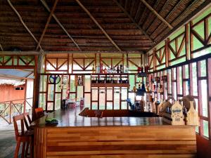 伊基托斯Milía Amazon Lodge的一间设有酒吧的客房,位于一栋带窗户的建筑内