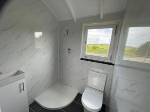New AberdourAC/DC Glamping的白色的浴室设有卫生间和窗户。