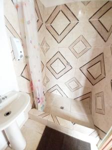 Marigot多米尼加宁静小屋酒店的浴室配有白色水槽和瓷砖地板。