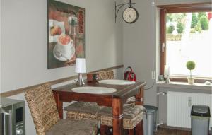 戈斯拉尔Beautiful Apartment In Goslar With Kitchen的一间设有桌椅和墙上时钟的房间