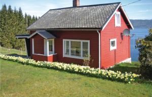 HjelvikStunning Home In Vgstranda With Kitchen的草上花似的红色小房子