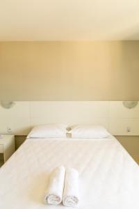 萨尔瓦多普拉提奴姆酒店的白色床上的2条毛巾
