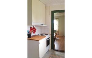LundsbrunnAmazing Home In Lundsbrunn With 3 Bedrooms的厨房配有白色橱柜和炉灶烤箱。