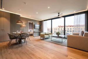 瓦伦西亚Apartamentos Core Suites Valencia的客厅配有桌椅和沙发
