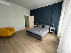 布达佩斯Astoria Downtown Superior的一间卧室配有一张床和一张黄色椅子