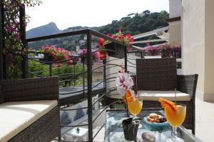 维耶特里Aretusa Resort Amalfi Coast的阳台配有桌子和两杯橙汁
