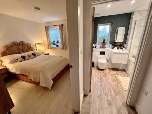 温莎Windsor, LEGOLAND, Ascot & Windsor RACECOURSE sleeps 3的一间带大床的卧室和一间浴室