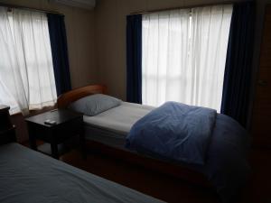 富山Guest House Inujima / Vacation STAY 3516的一间小卧室,配有两张床和窗户