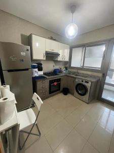 西迪拉哈尔Superbe appartement en résidence avec piscine的厨房配有不锈钢冰箱和洗碗机