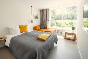 斯霍尔Villa de Hazelaar的一间卧室设有一张大床和一个窗户。