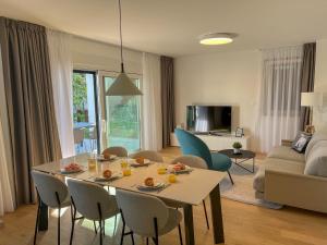 科济诺Zadar Premium Apartments的一间带桌椅的客厅和一间客厅。