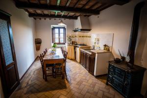 皮蒂利亚诺Le Antiche Viste的厨房配有桌子、冰箱和炉灶。