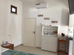 斯佩基亚Lu Caleddhu的厨房设有白色门和冰箱。