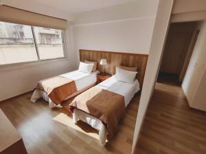 布宜诺斯艾利斯Precioso departamento en el centro de la ciudad的酒店客房设有两张床和窗户。