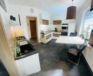 AuerbachFerienwohnung Ziegenschweiz的厨房配有桌子和白色台面