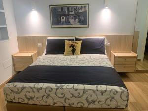 法诺Guest House Vagamondo的一间卧室配有一张带2个床头柜的大床