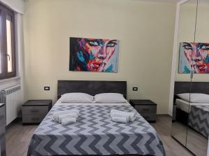 加利波利B&b tra scirocco e tramontana的卧室配有一张床,墙上挂有两幅画