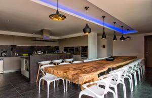 博尼法乔维森马奎斯圣马扎酒店的厨房里配有一张大木桌和白色的椅子