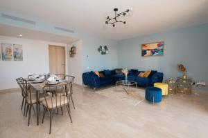 阿加迪尔Blu paradise,a ray of sunshine between sea & pool的客厅配有蓝色的沙发和桌子