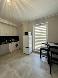 马尔基Noclegi Marki的厨房配有冰箱、桌子和窗户。