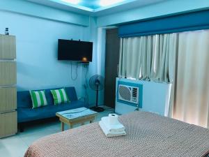 马尼拉Apartments across NAIA Terminal 3的蓝色的卧室配有床和沙发