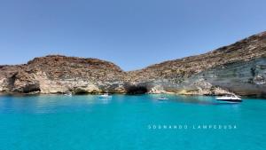 兰佩杜萨Sognando Lampedusa的悬崖边的水中一群船
