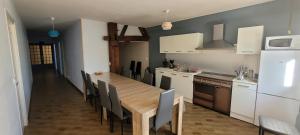 RahonLe Domaine du Bien-Être的厨房配有长木桌子和椅子