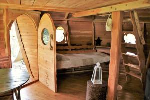 Saint-Hilaire-en-MorvanCabane Perchée dans les Arbres的小木屋内一间卧室,配有一张床