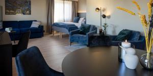 莱旺厄尔Thon Partner Hotel Backlund的客厅配有蓝色家具和桌椅