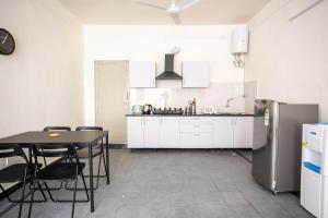 海得拉巴Neemtree Apartments的厨房配有桌子和冰箱