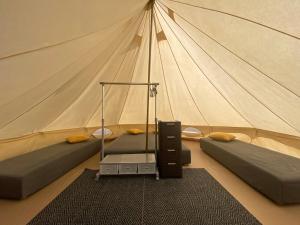 KõrkkülaMereoja Camping的帆布帐篷 - 带两张床和一个带帐篷的房间