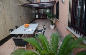 拉科萨Raxó con piscina en la urbanización的种植了植物的阳台配有白色的桌椅
