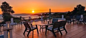 阿兰扎达艾斯特拉马尔酒店的庭院配有桌椅,享有日落美景。