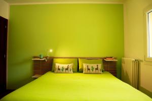 拉奎拉Sweet Home的绿色卧室,配有一张带绿色墙壁的床
