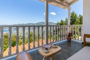 斯科派洛斯Liagka Villa的阳台配有桌子,享有海景。