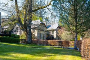 莫顿汉普斯泰德博维城堡酒店的一座大石头房子,院子里有树木