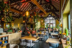 古尔彭EuroParcs Gulperberg的一间带木桌椅的餐厅和一间酒吧