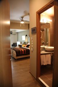 斯泰尼杜伊费奥斯木斯克潘多克西奥旅馆的浴室设有床、水槽和镜子