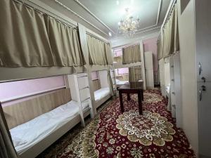 杜尚别Bruce hostel的客房设有两张双层床和一张桌子。