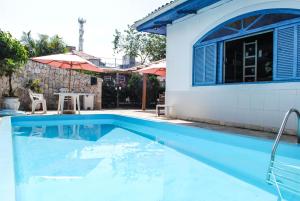 弗洛里亚诺波利斯World Hostel - Canasvieiras的房屋前的游泳池