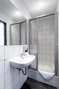 雷根斯堡雷根斯堡奥斯特甜梦酒店的白色的浴室设有水槽和淋浴。