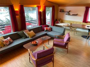 瓦尔贝拉La Civetta (714 La)的客厅配有蓝色的沙发和紫色的椅子