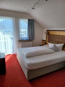 奥伯斯特多夫维特尔斯巴赫霍夫酒店的一间卧室设有一张大床和一个大窗户